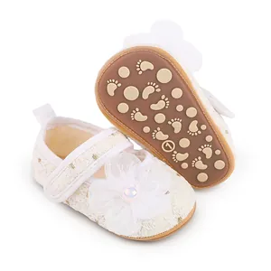 Detaillierte Nahaufnahme von weißen Baby-Prinzessin-Schuhen aus Spitze mit weichen Sohlen