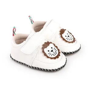 Detailed view of white baby walkers featuring cute cartoon lion patches and Velcro straps.