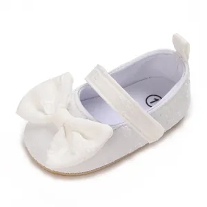 Detailansicht weißer Lauflernschuhe für Babymädchen mit einer großen, eleganten Schleife