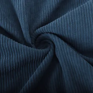 Detailed macro view showing the rich textured ridges of navy blue corduroy shirt fabric.