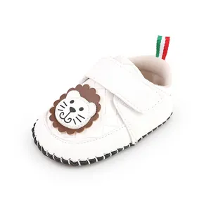 Side view of white cartoon baby walking shoe with lion patch and Velcro strap