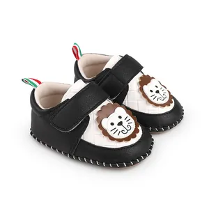 Detailed view of cute cartoon lion pattern on black and white baby walking shoes