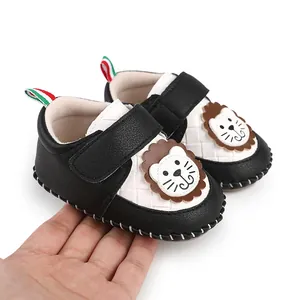 Detailed view of baby walking shoes with cute cartoon lion face and velcro strap