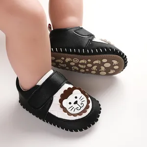 Close-up of black and white cartoon lion baby pre-walker shoes with anti-slip soft soles