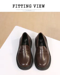 High-quality detailed view of classic brown British style girl's leather loafers for school