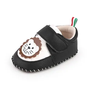 Close-up of baby pre-walker shoes featuring a cute cartoon lion applique on the toe.