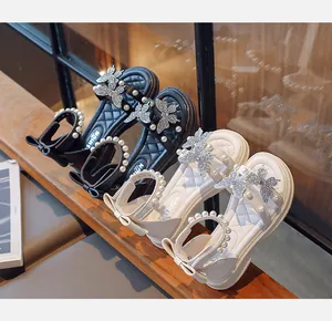 Elegant girls sandals featuring pearl ankle straps and sparkling rhinestone butterfly charms