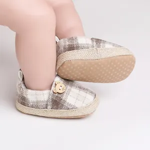 Detail view of plaid baby walking shoes with soft anti-slip dotted soles