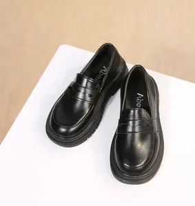 Detail view of stylish black girls' British style leather loafers for school performance