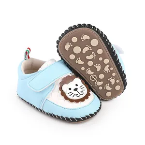 Detail view of blue cartoon baby walking shoes with anti-slip sole and lion patch.