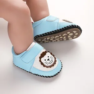 Detail view of blue baby pre-walker shoes with cartoon lion design and non-slip sole