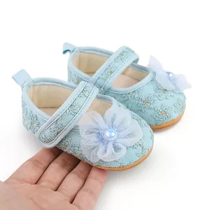 Detailansicht der hellblauen Baby-Prinzessin-Schuhe aus Spitze im Größenvergleich