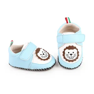 Detailed view of light blue baby walking shoes featuring a cute cartoon lion patch and velcro strap