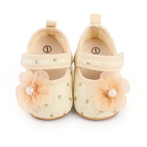Detailansicht cremefarbener Baby-Prinzessin-Schuhe mit Spitzenstickerei und Perlenblume