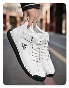Detailed close-up shot of white hand-stitched men's leather leisure shoes with black sole