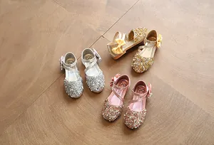 Glittery girls' Mary Jane shoes in silver, gold, and pink with elegant bow details.