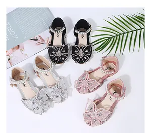 Detailed view of sparkling girls princess shoes with pearl and butterfly rhinestones
