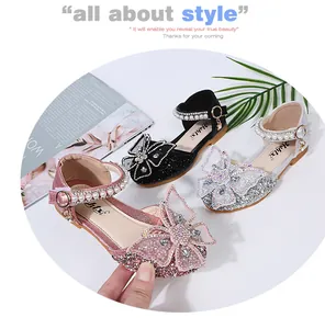 Detail view of sparkling princess shoes for girls with rhinestone butterfly bows