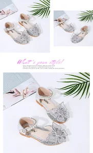 Close-up of silver glittery girls' princess shoes with butterfly bow and pearls.