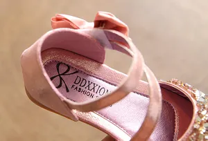 Detailed macro shot showing the insole and pink sequin texture of this girl's flat shoe.