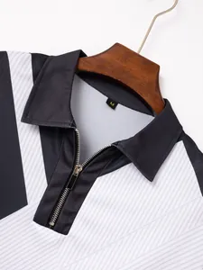 Close-up of men's color-block polo shirt featuring a lapel collar and zipper detail