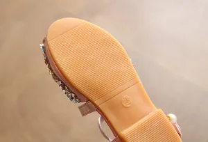 Close-up of anti-slip rubber sole on children's flat shoes with size 28 marking