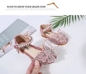 Detail of pink glitter princess shoes for girls with butterfly and pearl strap