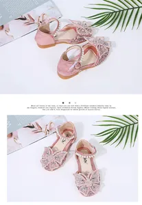 Detailed view of pink glitter girl's princess shoes with butterfly bows and pearls