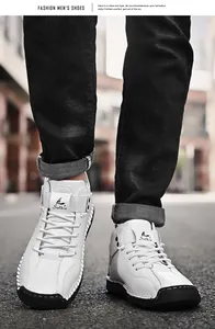 Detailed close-up of white men's leather casual shoes with manual stitching details.