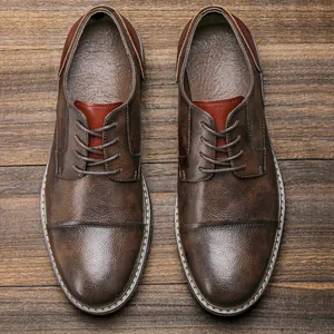 Top-down view of men's vintage brown business casual oxford shoes on wooden background