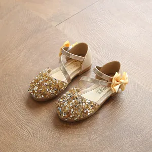Sparkling golden sequin girls' dress shoes featuring elegant yellow bow and pearl accent