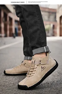 Close-up of hand-stitched men's casual leather loafers in beige with flat sole