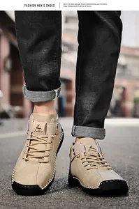 Detailed view of khaki hand-stitched men's casual leather shoes on an urban street