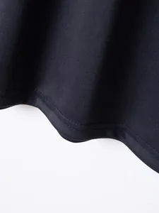 Close-up detail of a premium black polo shirt hem featuring durable double stitching craft