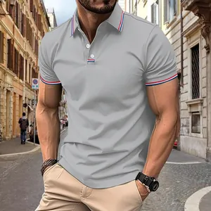 Detail view of a men's grey casual polo shirt with striped trim in a street setting