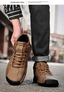 Close-up of hand-stitched men's casual brown leather loafers on street