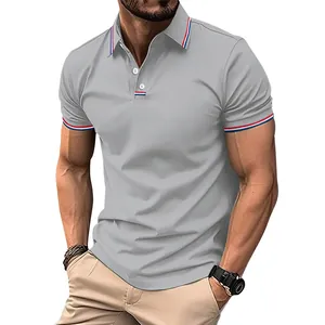 Close-up of men's grey polo shirt with red and blue striped trim on collar and cuffs.