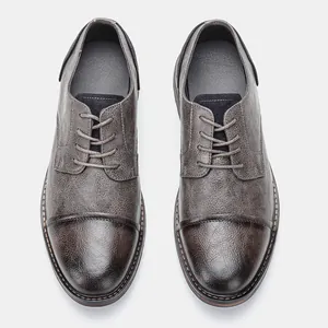 Top-down view of men's business casual leather shoes with burnished toe detail