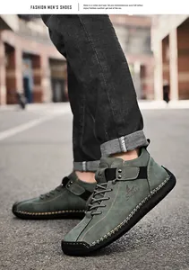 Close-up of green men's leather shoes with hand-stitched details and Salkin logo.