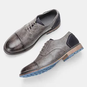 Classic men's burnished leather dress shoes featuring unique blue textured outsole detail