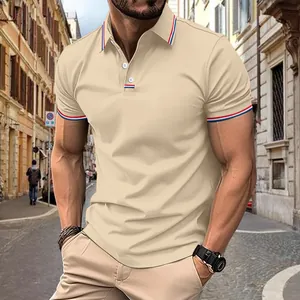 Detailed view of men's beige polo shirt with striped collar and cuffs details