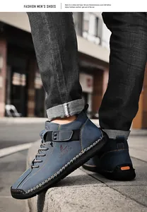 Close-up of blue hand-stitched men's casual leather loafers in an urban street setting
