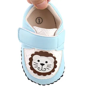 Close-up of light blue baby walker shoe featuring a cute cartoon lion design