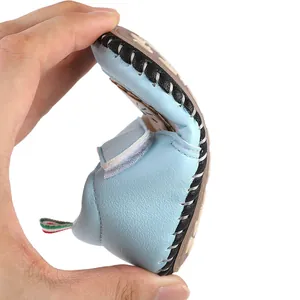Detailed macro shot of flexible light blue baby walking shoe demonstrating its soft sole