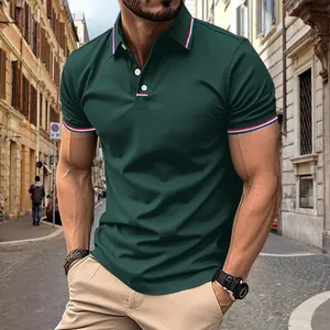 Detail view of dark green men's polo shirt with striped collar and cuff accents