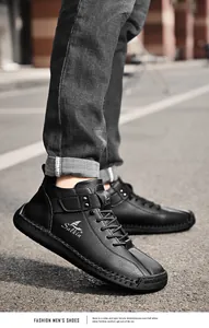 Close-up detail of men's black leather casual shoes with unique hand-stitched seams