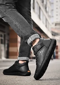 Close-up of black men's casual leather shoes with handmade stitching and logo detail