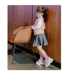 Detailed view of girls' silver chunky sneakers with pearl lace and breathable mesh.