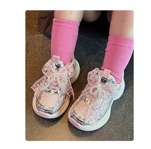Detail shot of girls' pink mesh sneakers featuring elegant lace and pearl bow accents.