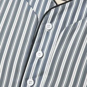 Detail view of v-neck striped nightshirt featuring white buttons and black piping